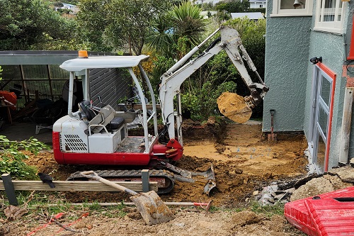 2t digger preparing ground for a new patio