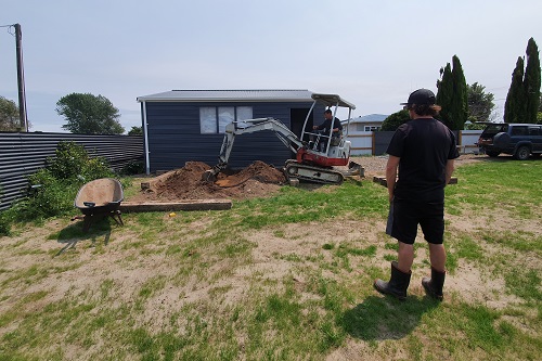 Photo - digger preparing ground for a vegetable patch.